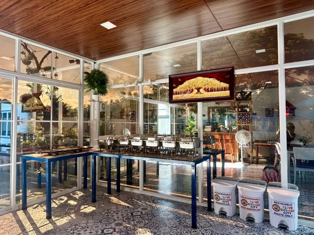 Glass buffet hall with chafing dishes at golden hour