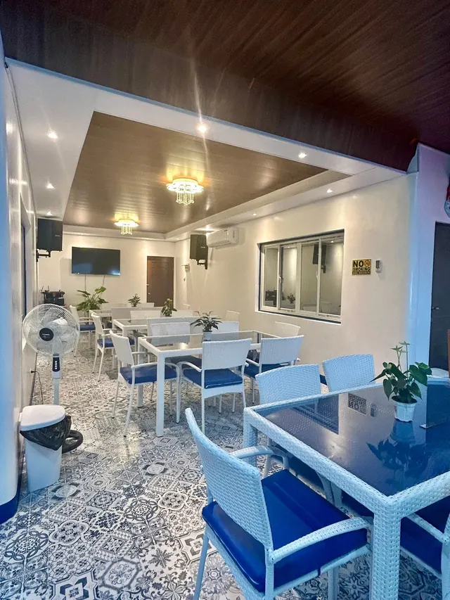 Air-conditioned function hall with white chairs