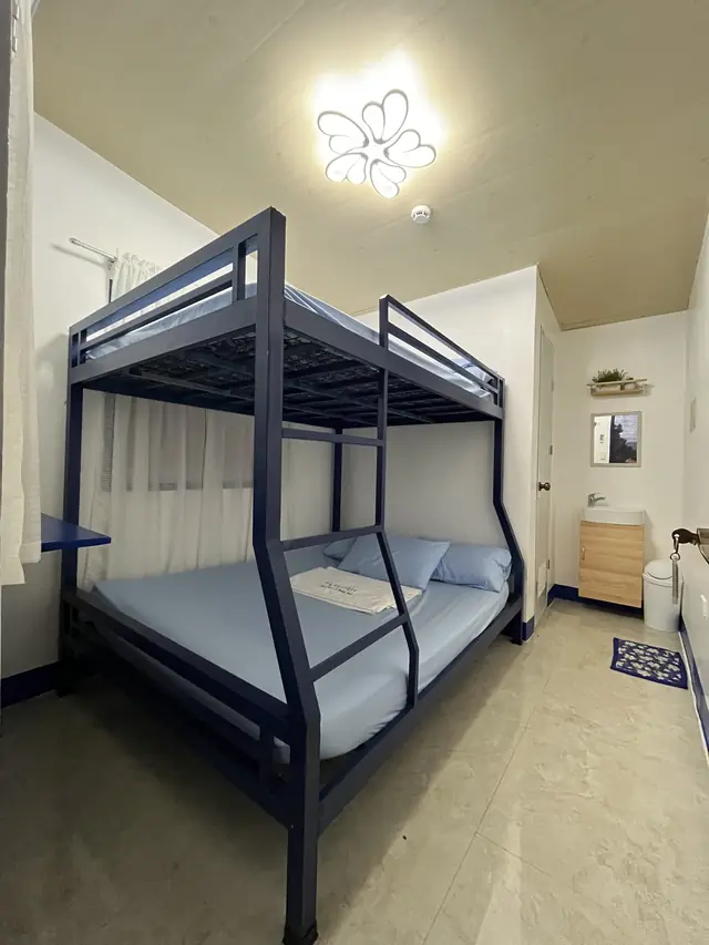 Air-conditioned room with a navy bunk bed at T.A. Faytaren in Batangas City