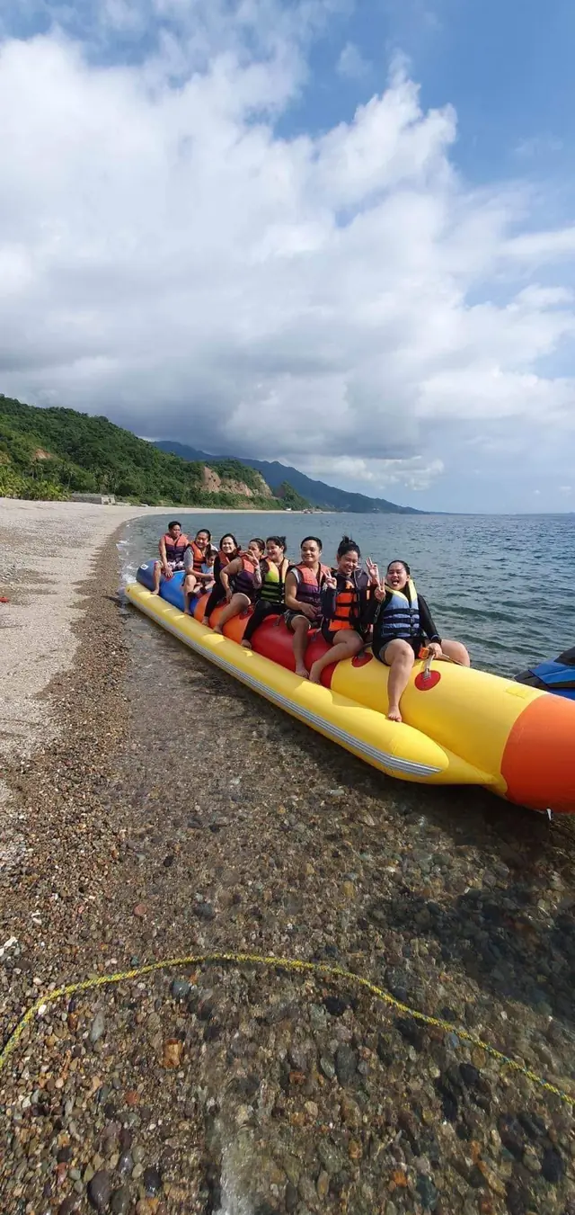 Banana boat pulled up on the pebble beach