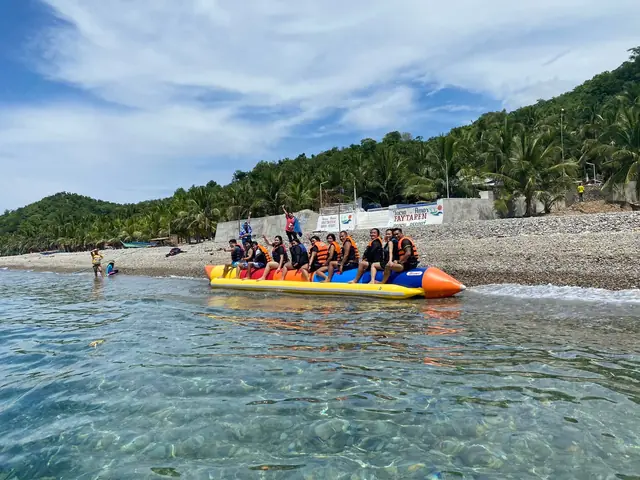 Banana boat in clear water off the shore