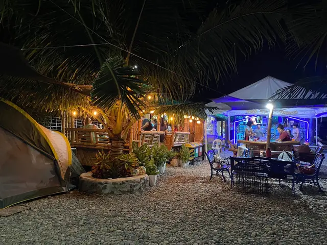 Lounge and lights by the shore at night