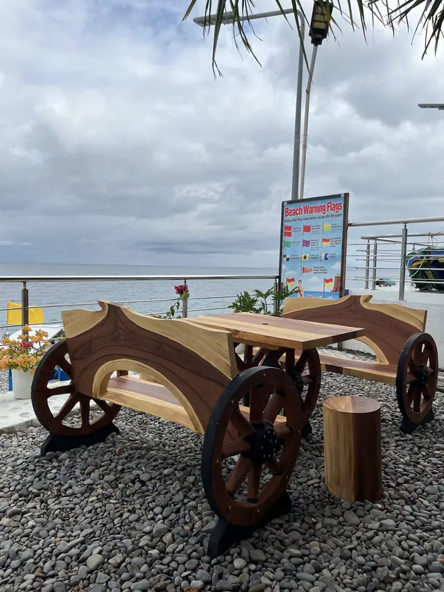 Wooden cart tables on the pebble shore