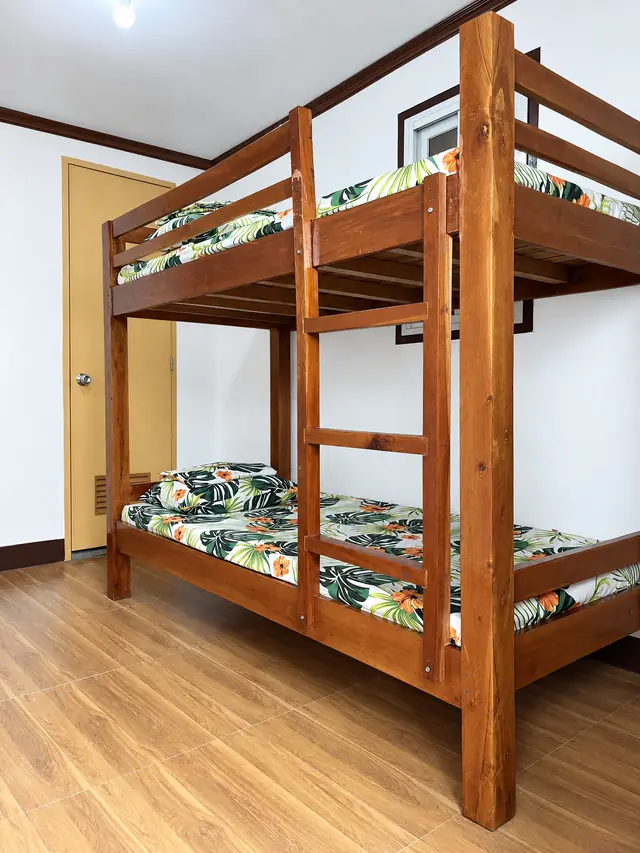 Family room with wooden bunk beds and tropical sheets