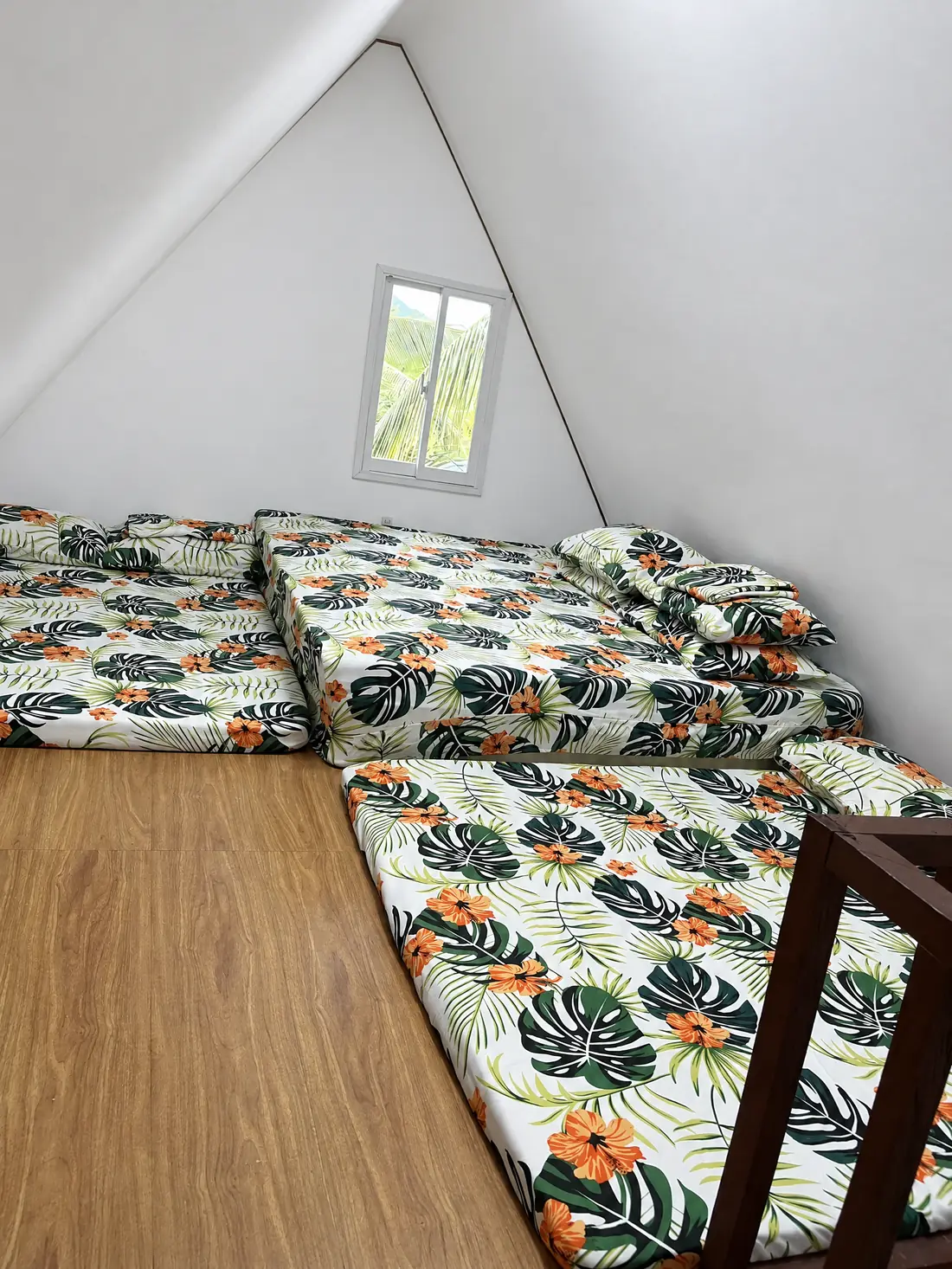 Family room loft with floor mattresses under an A-frame roof