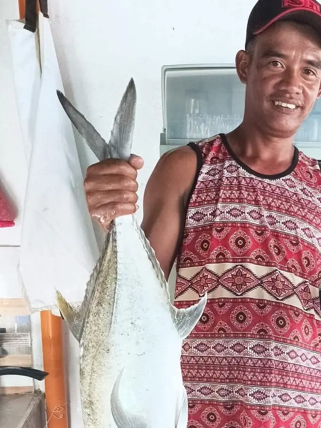 Guest holding a big fish at the resort