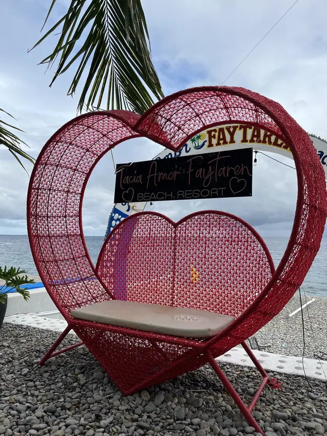Red heart swing seat facing the sea