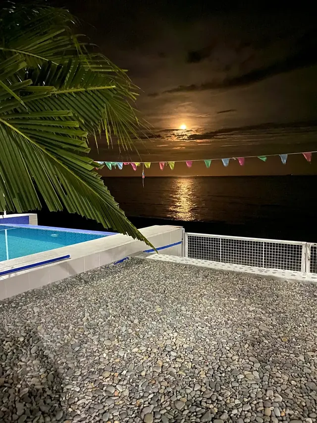 Moonrise over the pool and the sea
