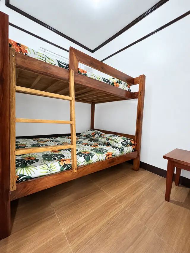 Wooden bunk beds with tropical leaf sheets