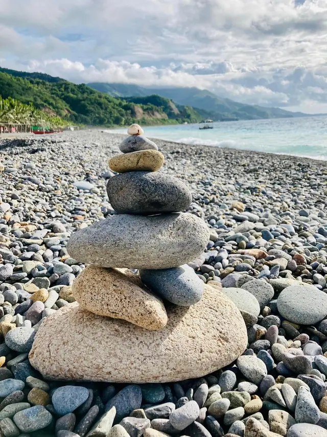 Stacked stones on the pebble beach of Lobo