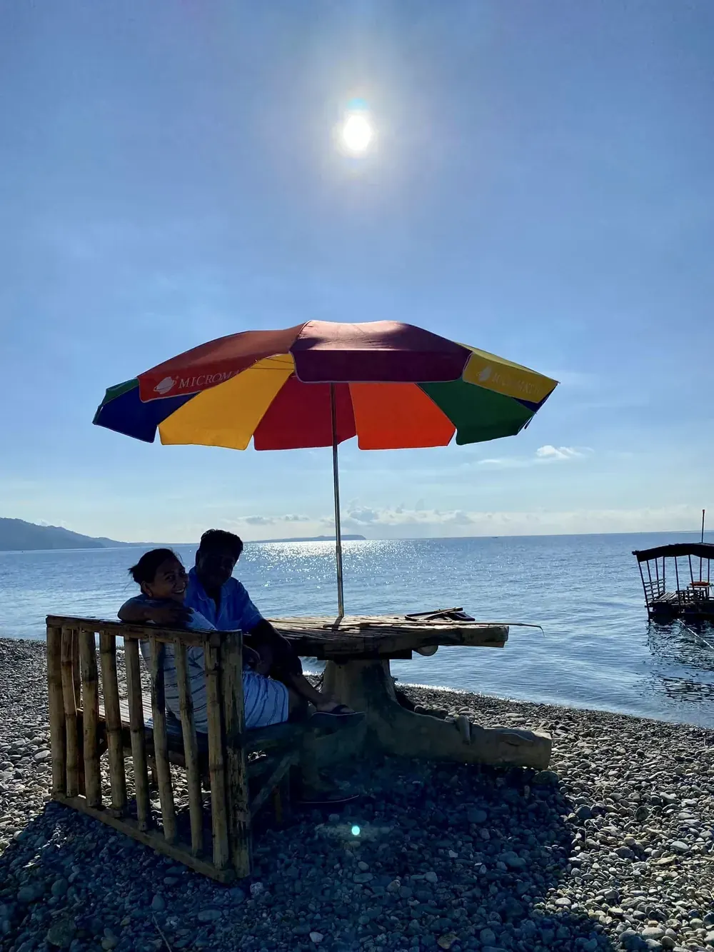 Beach umbrella and table on the shore