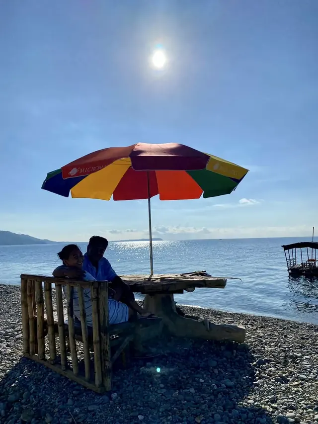 Umbrella table on the pebble shore